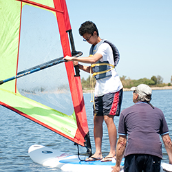 student learning to windsurf
