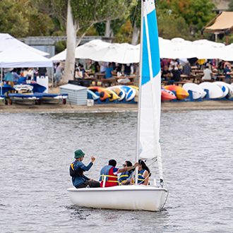 a group having a private sailing lesson on shoreline lake.