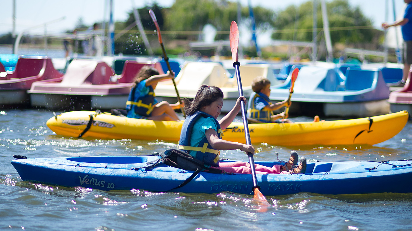 Three kids in their kayaks.