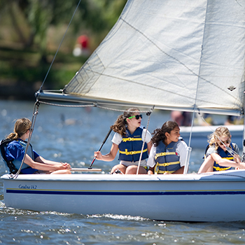 A group of girls sailing in a boat.