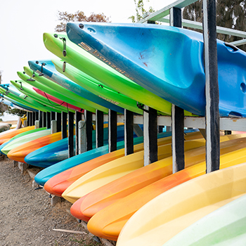Two teenage boys in a boat getting ready to sail at Shoreline Lake.
