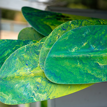 Three boys sailing a boat fast on Shoreline Lake.