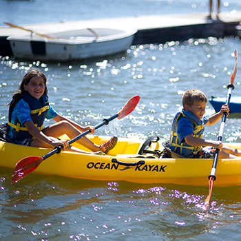 A young boy and girl in a kayak